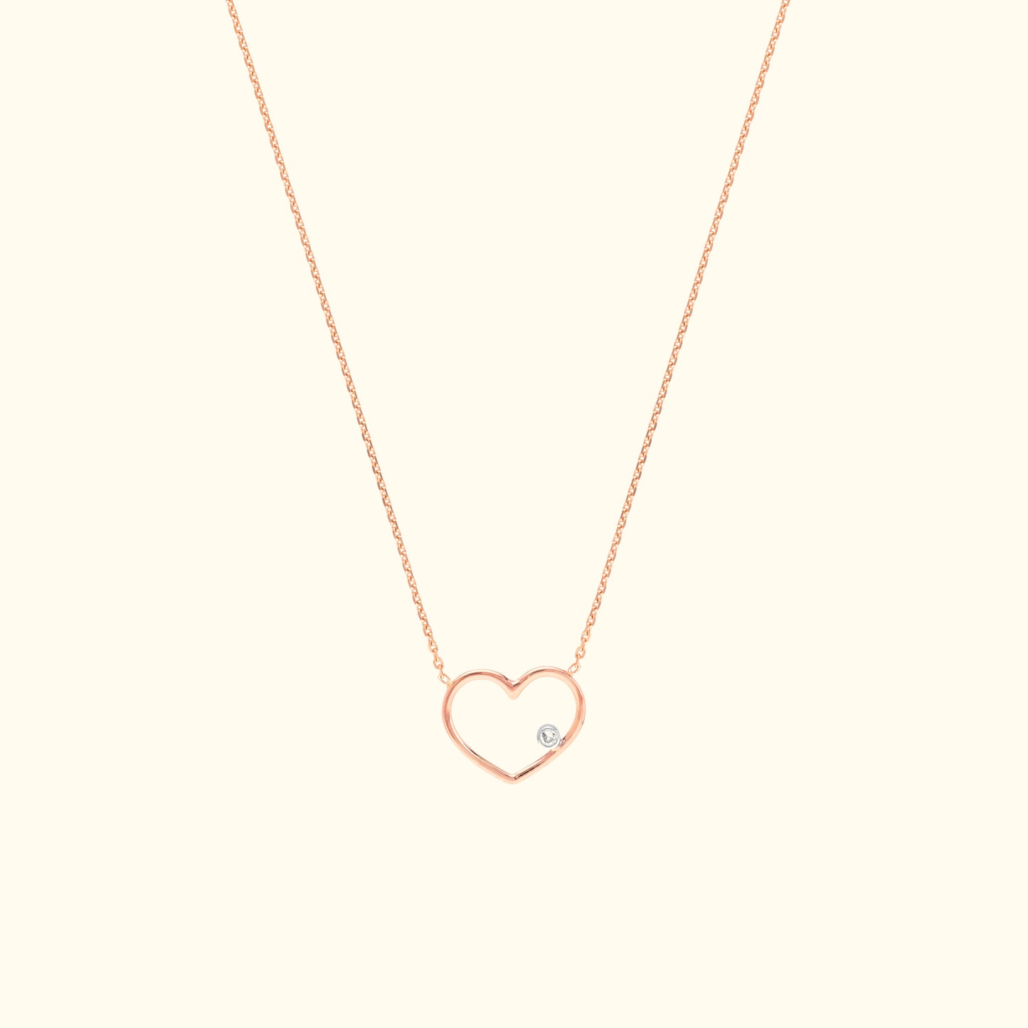 Rose gold heart necklace with a small diamond accent.