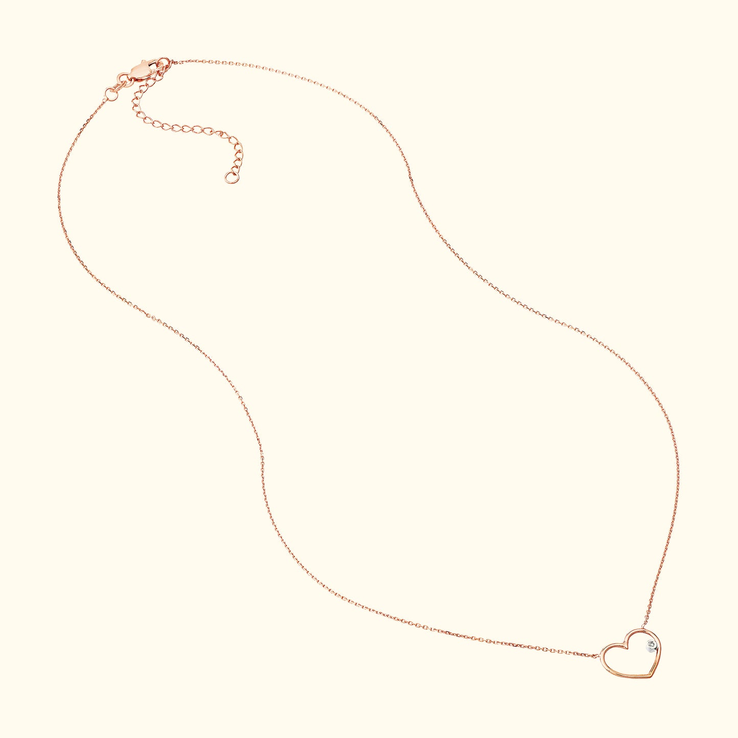 Delicate rose gold heart necklace with a small diamond accent.