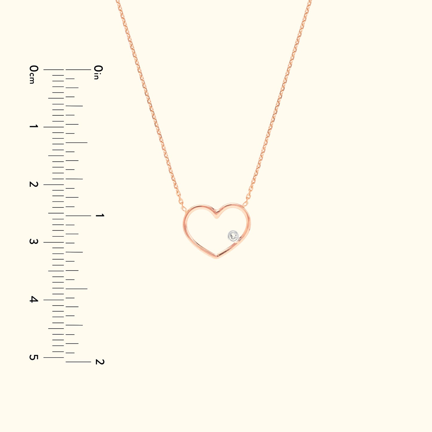 Rose gold heart necklace with a small diamond detail, displayed on a light background.