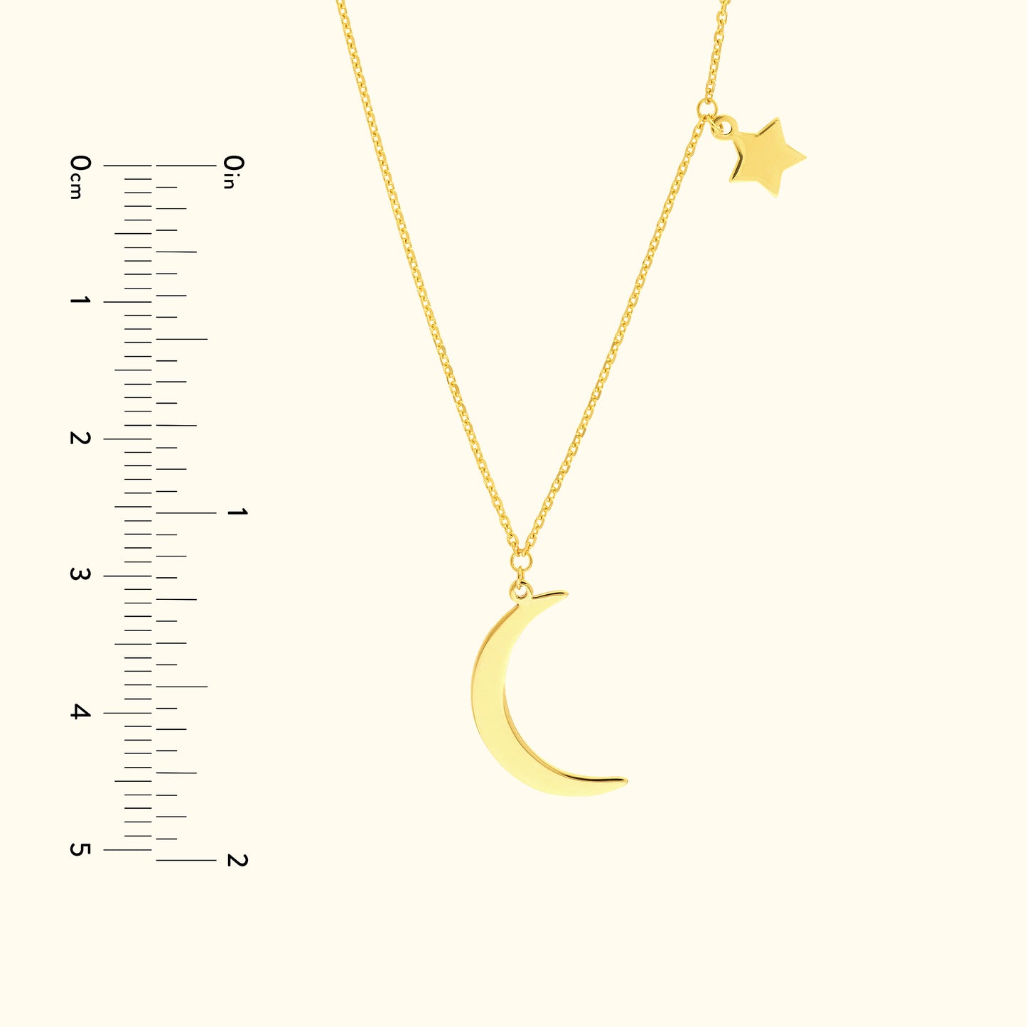 Gold pendant necklace featuring a crescent moon and a small star charm.