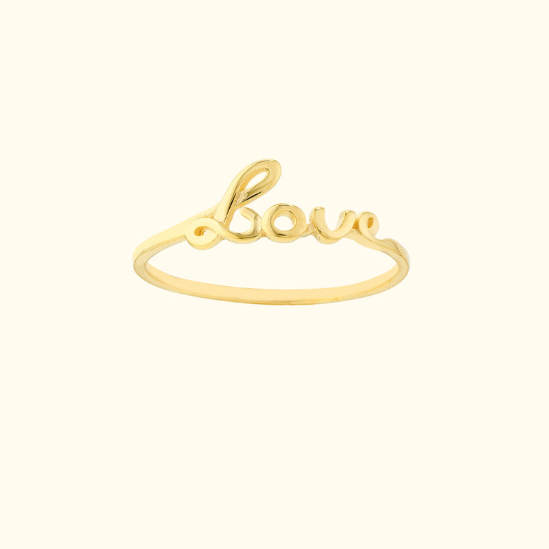 Gold ring with the word "Love" elegantly designed in a cursive font.
