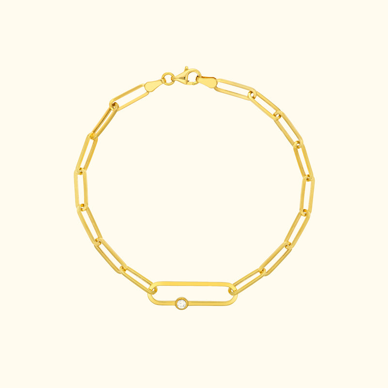 Gold link bracelet featuring a single diamond accent.