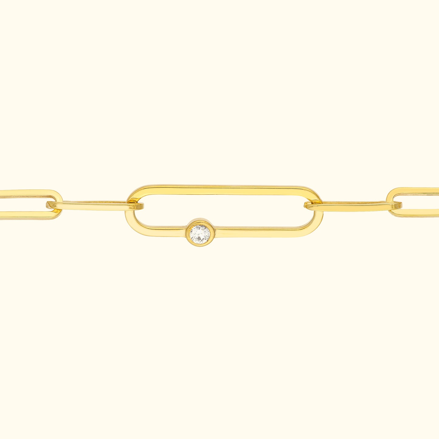 Gold chain bracelet with elongated links and a central diamond accent.