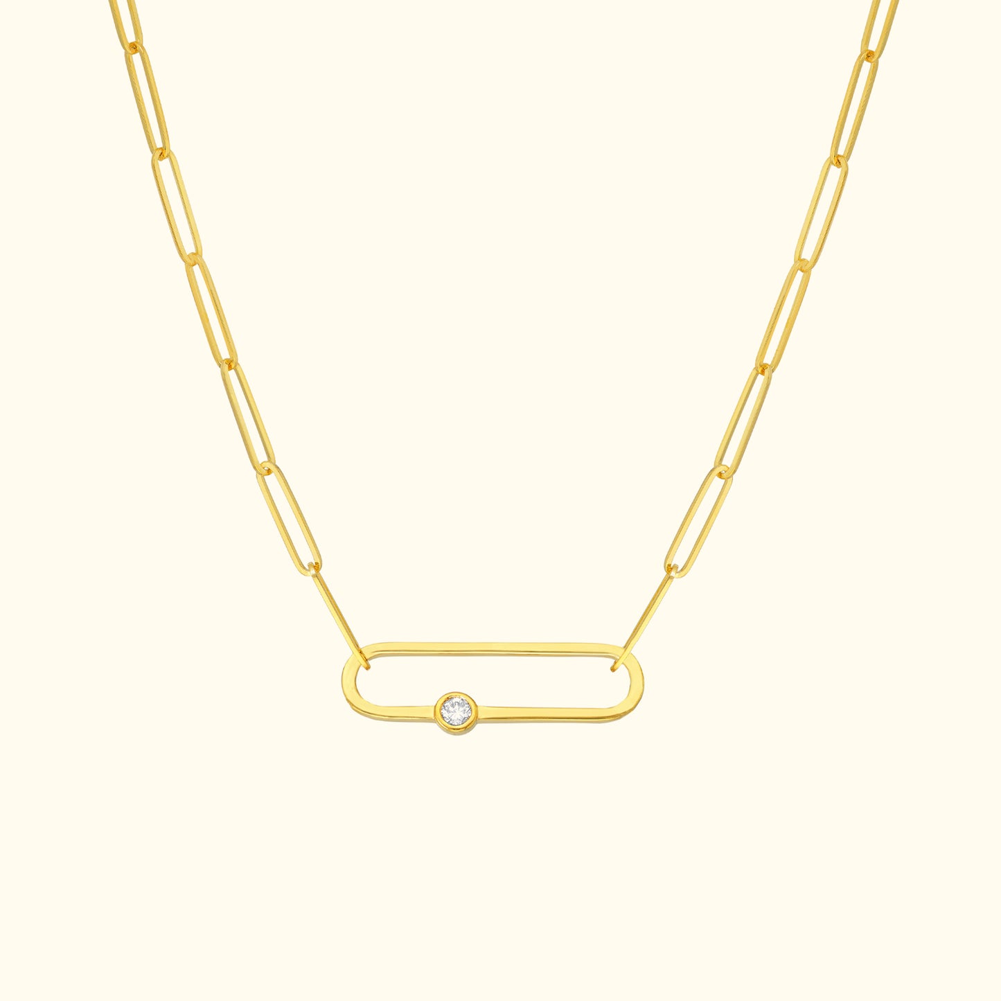 Gold chain necklace featuring an oval link and a central diamond accent.