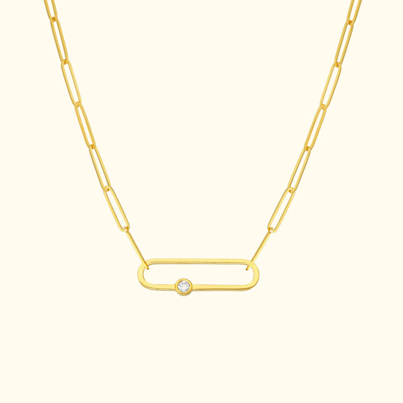 Gold chain necklace featuring an oval link and a central diamond accent.