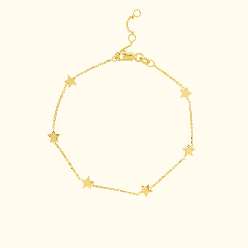 Delicate gold bracelet featuring star-shaped charms along a fine chain.