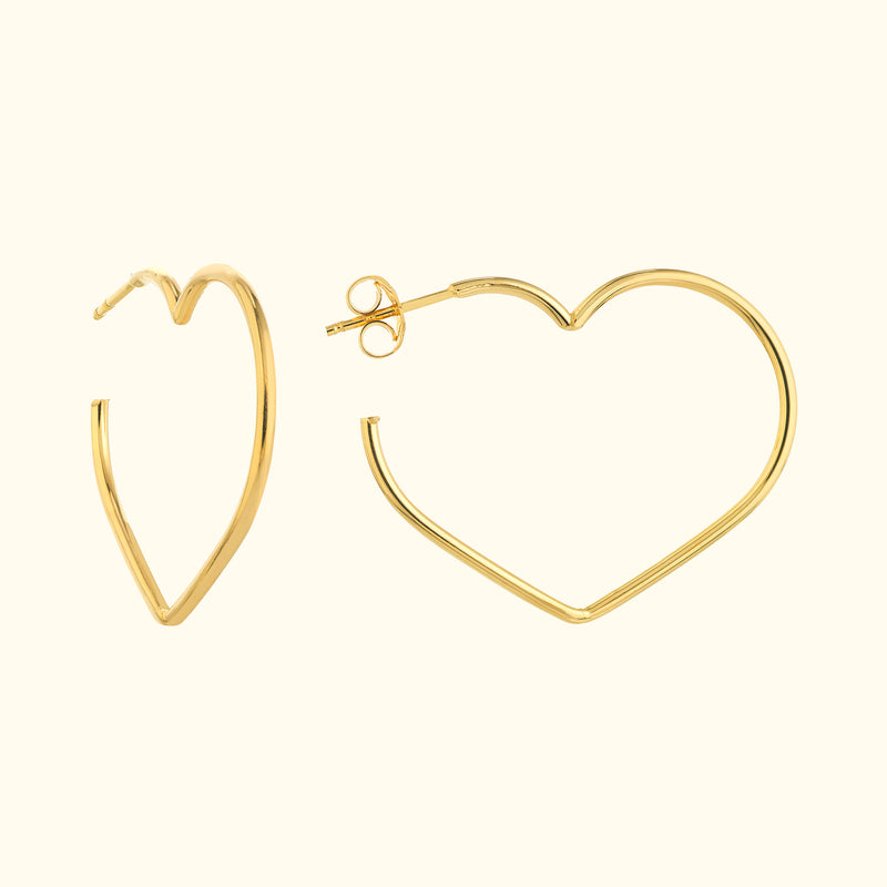 Gold heart-shaped hoop earrings displayed against a light background.