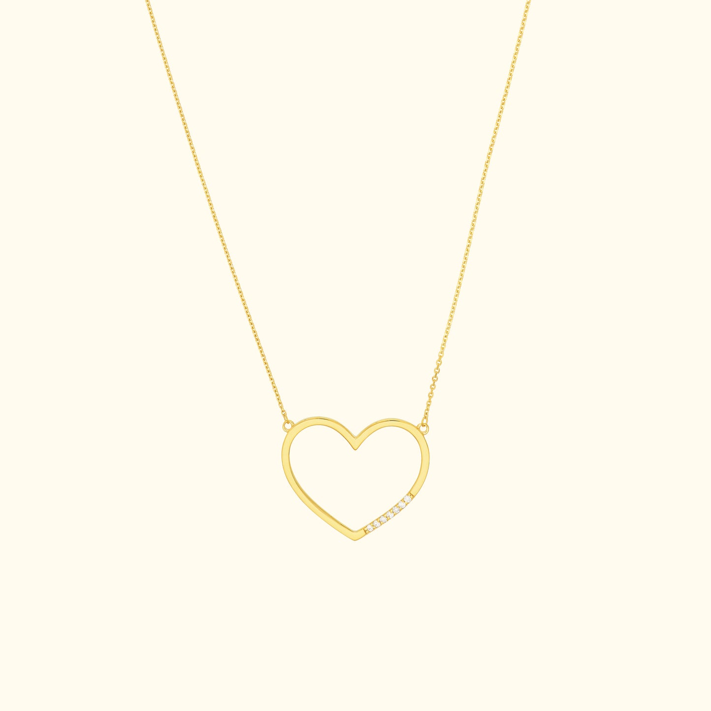 Gold heart-shaped necklace with a minimalist design and a single diamond accent.