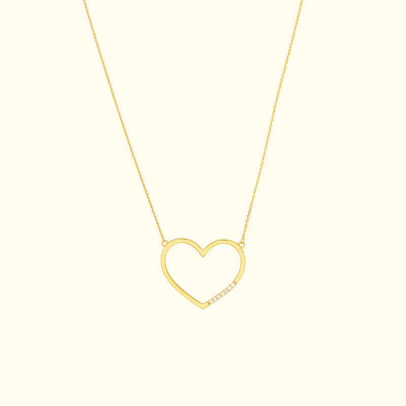 Gold heart-shaped necklace with a minimalist design and a single diamond accent.
