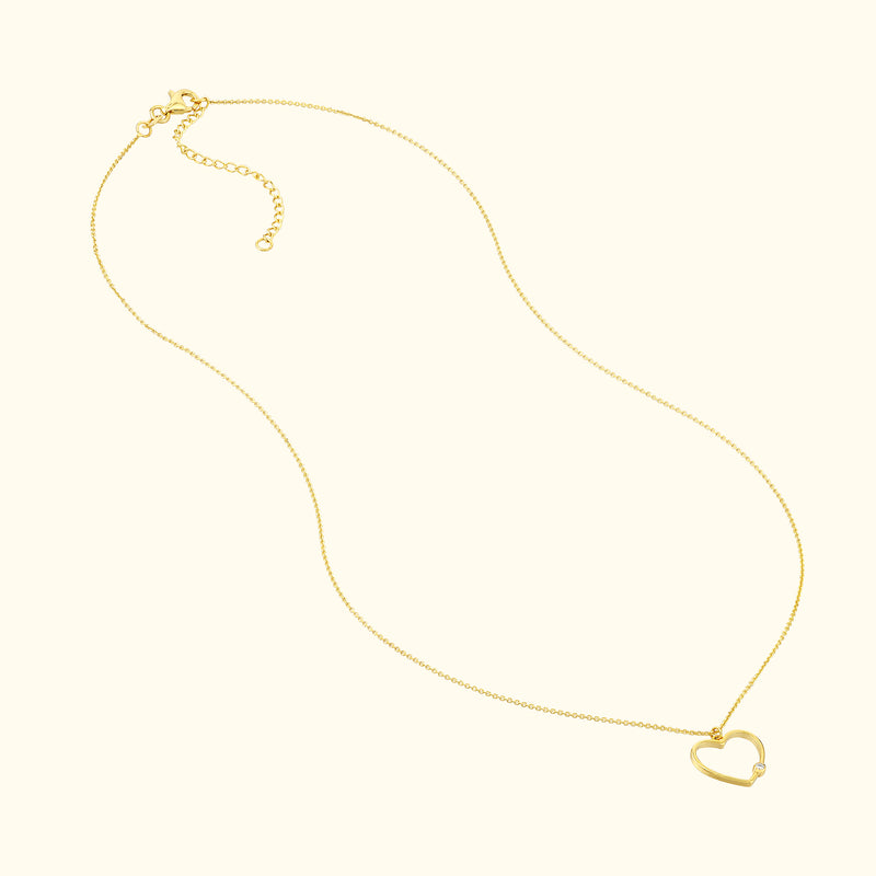 Delicate gold necklace with a heart-shaped pendant.