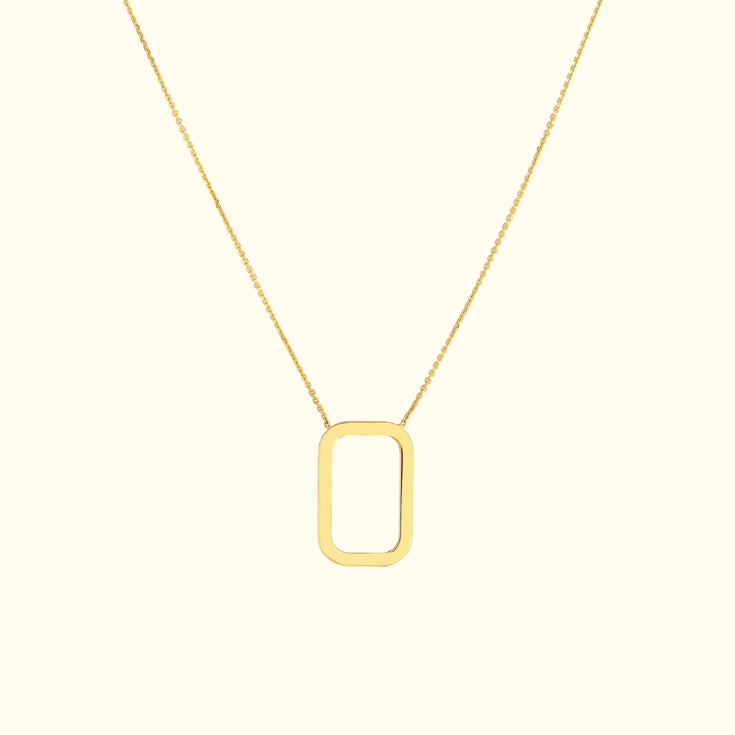 Gold necklace featuring a minimalist rectangular pendant on a delicate chain.