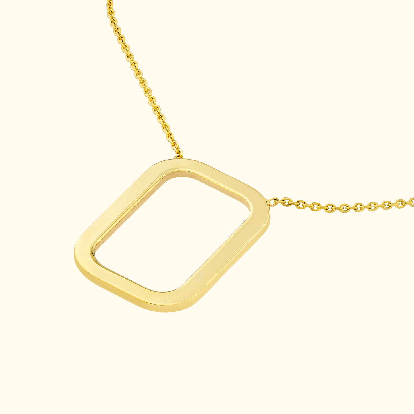 Gold rectangular pendant hanging from a delicate chain on a neutral background.