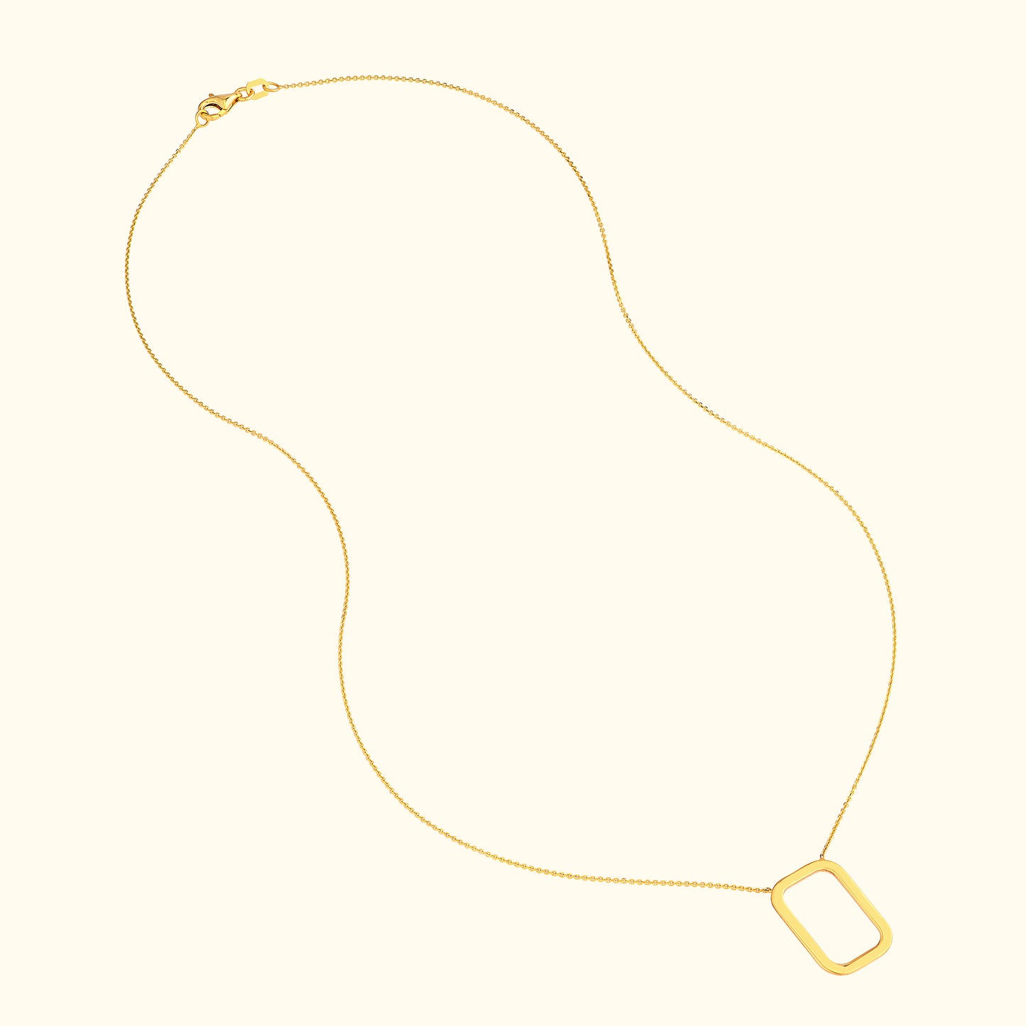 Delicate gold necklace with a rectangular pendant on a thin chain.