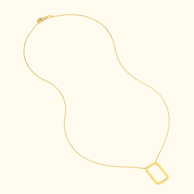 Delicate gold necklace with a rectangular pendant on a thin chain.