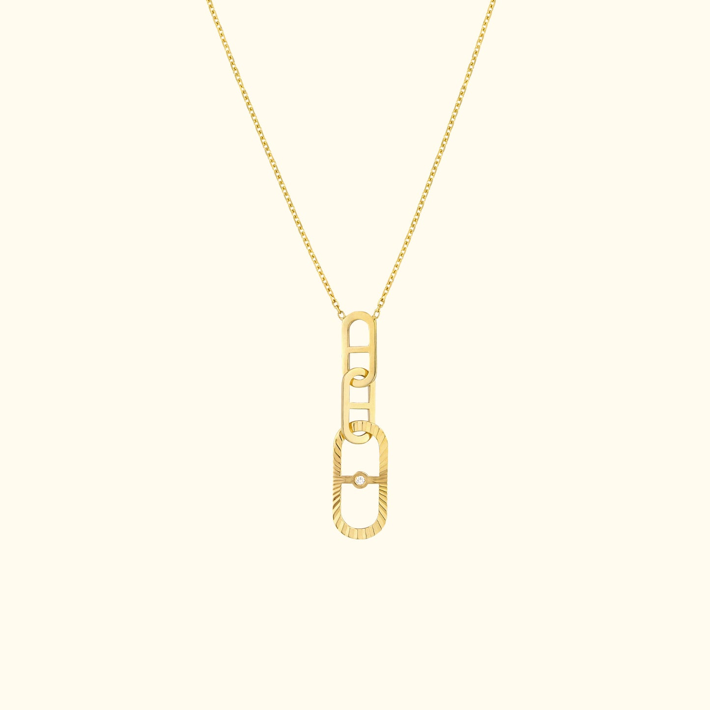 Gold chain necklace featuring a modern, interlocking link pendant.