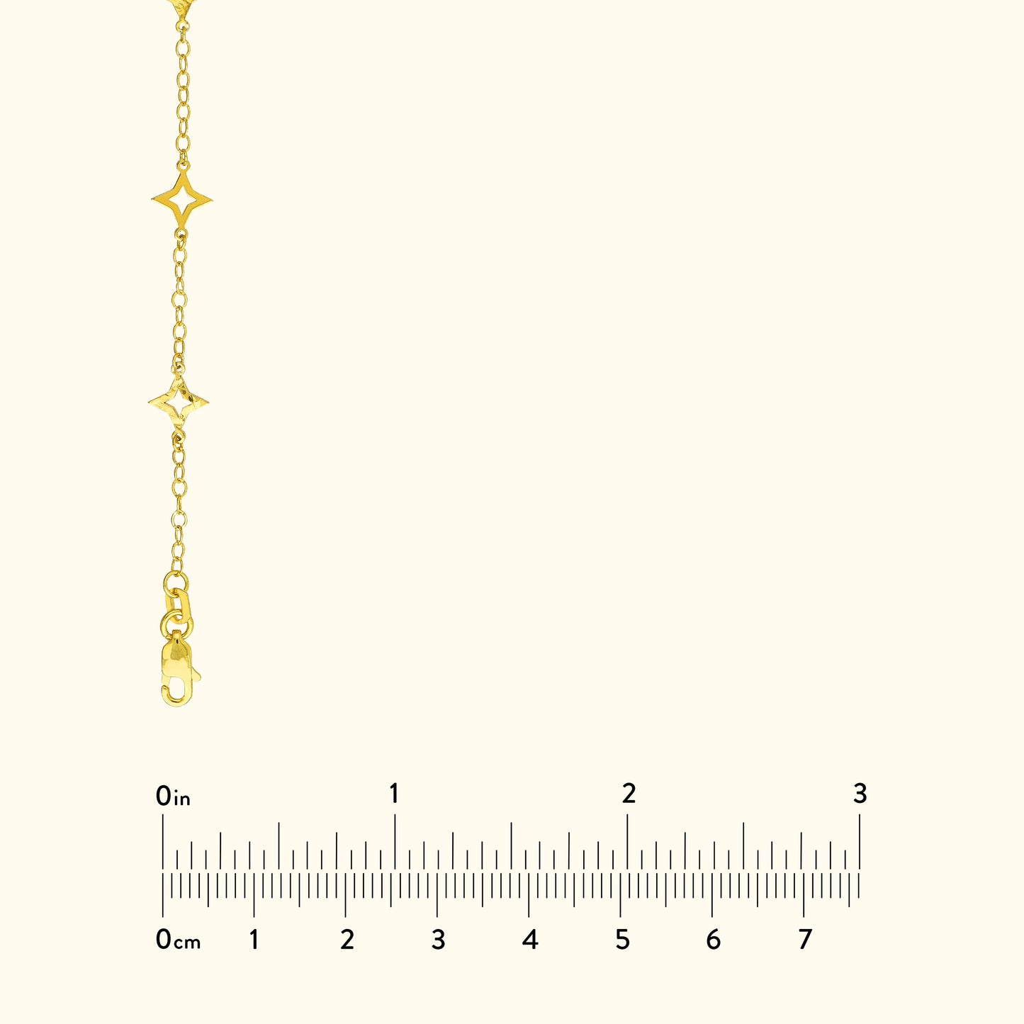 Gold chain necklace with star-shaped charms and a clasp, shown with a ruler for size reference.