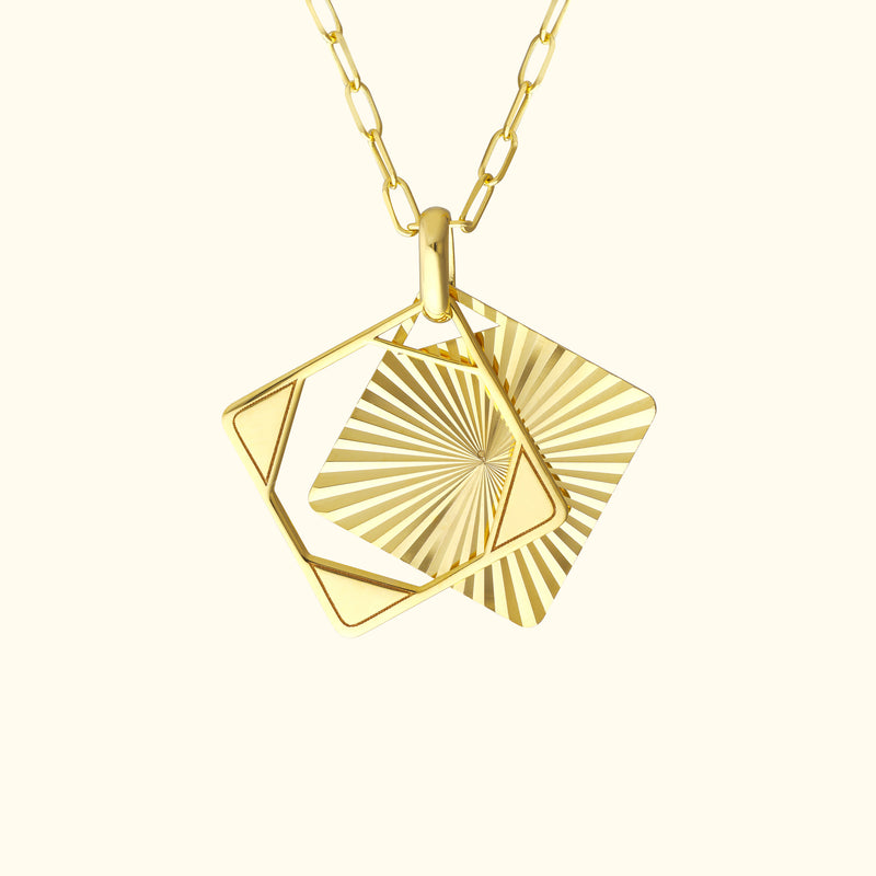 Gold necklace featuring two geometric pendants in a layered design.