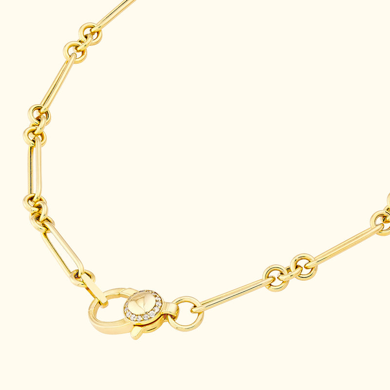 Gold chain necklace with interlocking links and a decorative clasp.