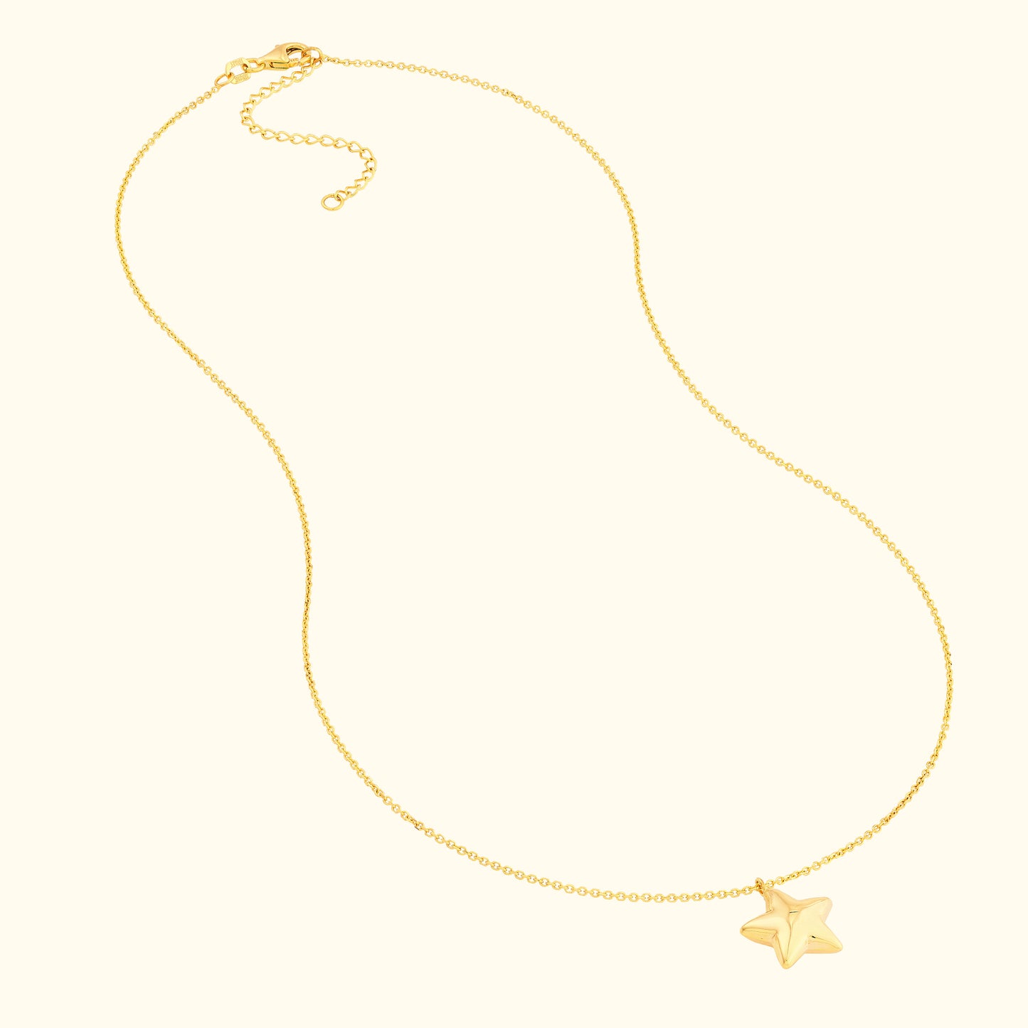 Delicate gold necklace featuring a small star pendant.
