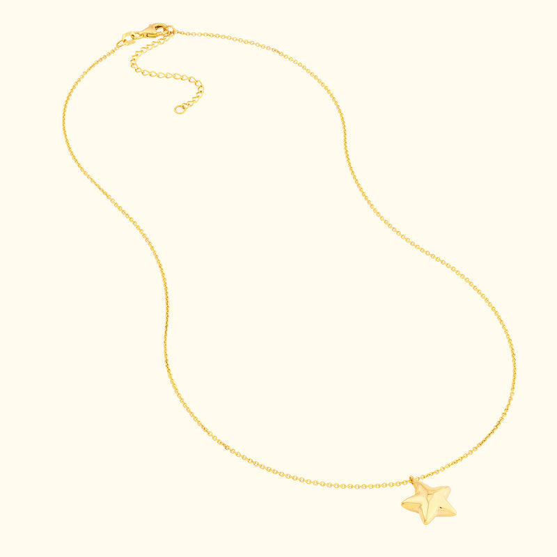 Delicate gold necklace featuring a small star pendant.