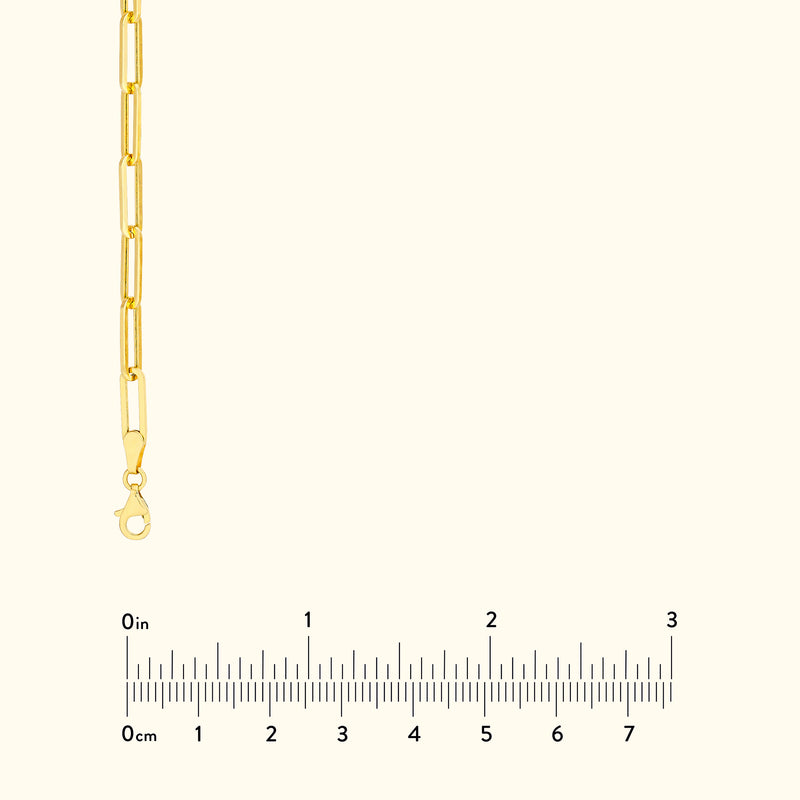 Gold chain bracelet with elongated links and a lobster clasp, displayed with a ruler.