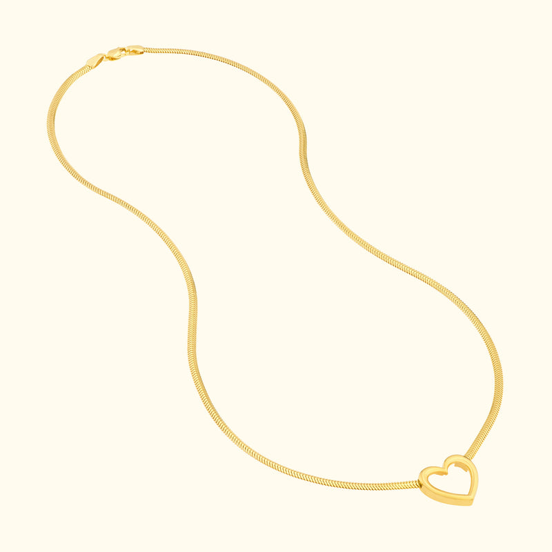 Glistening gold necklace featuring a heart-shaped pendant.