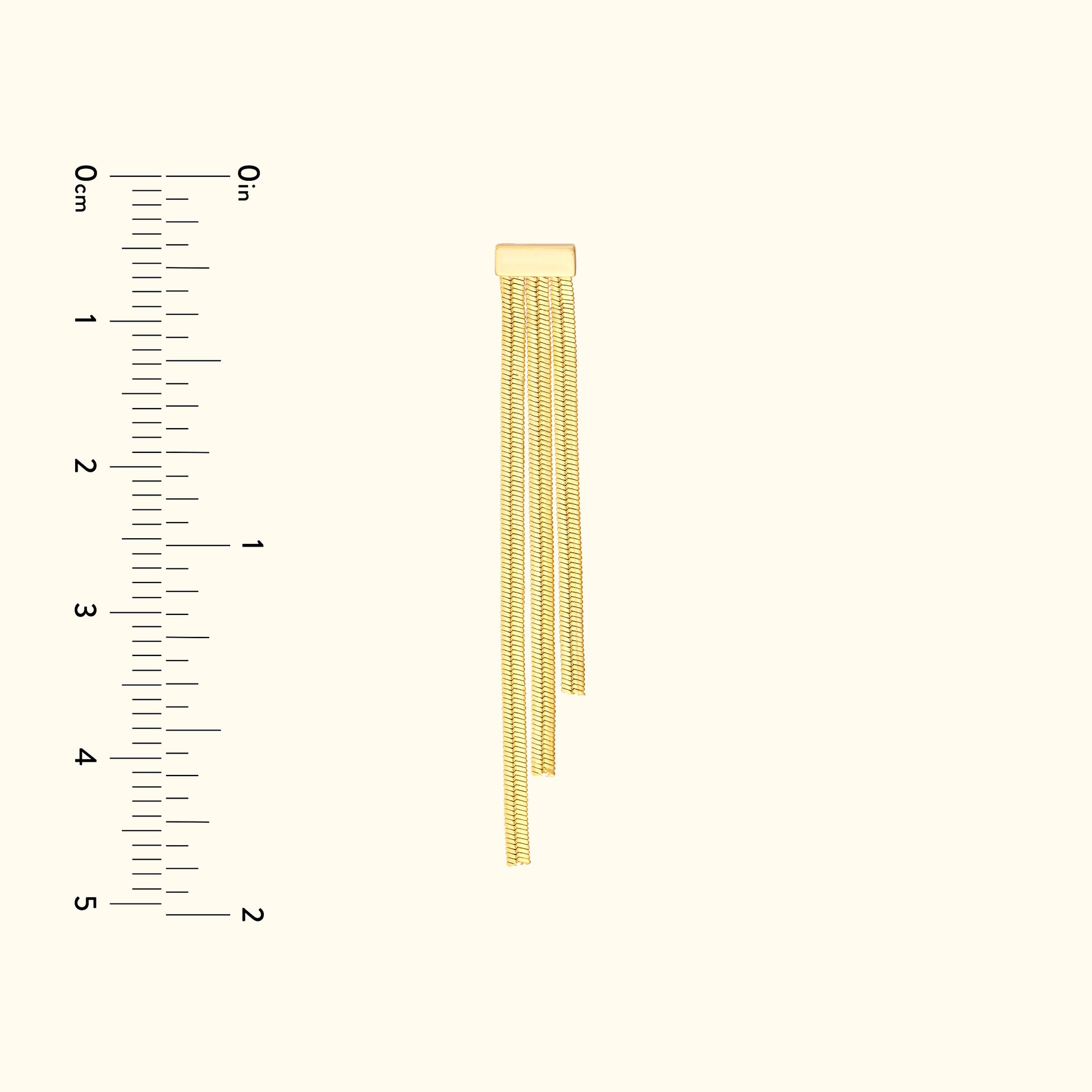 Gold chain with three dangling strands, displayed vertically beside a ruler for size reference.