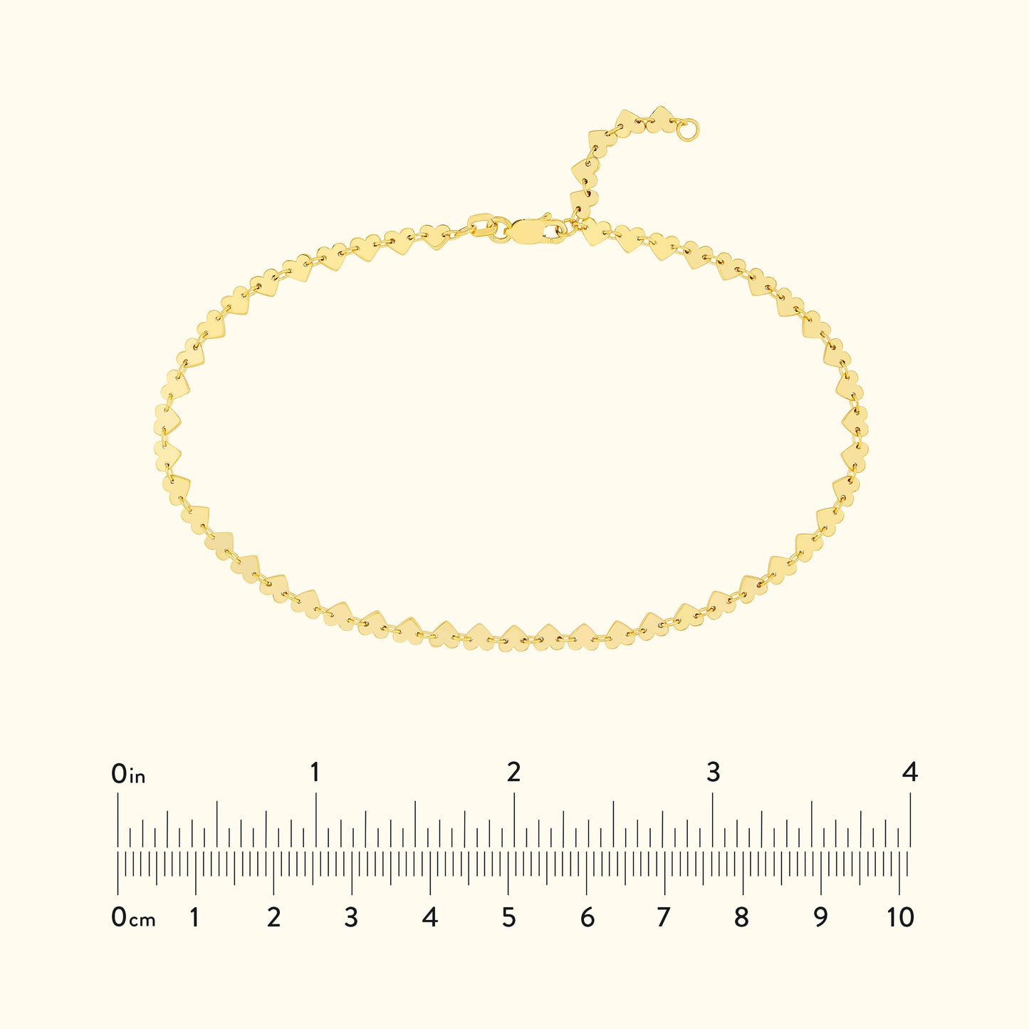 Gold bracelet with a zigzag design and adjustable clasp, displayed with a ruler for size.