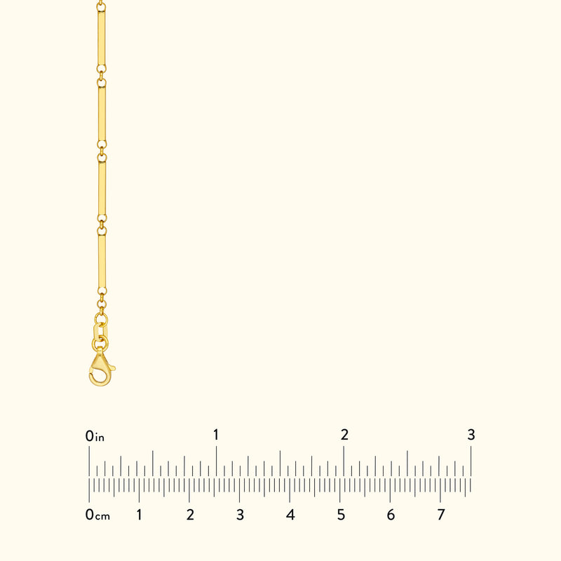 Gold link chain necklace displayed with a measuring ruler for size reference.