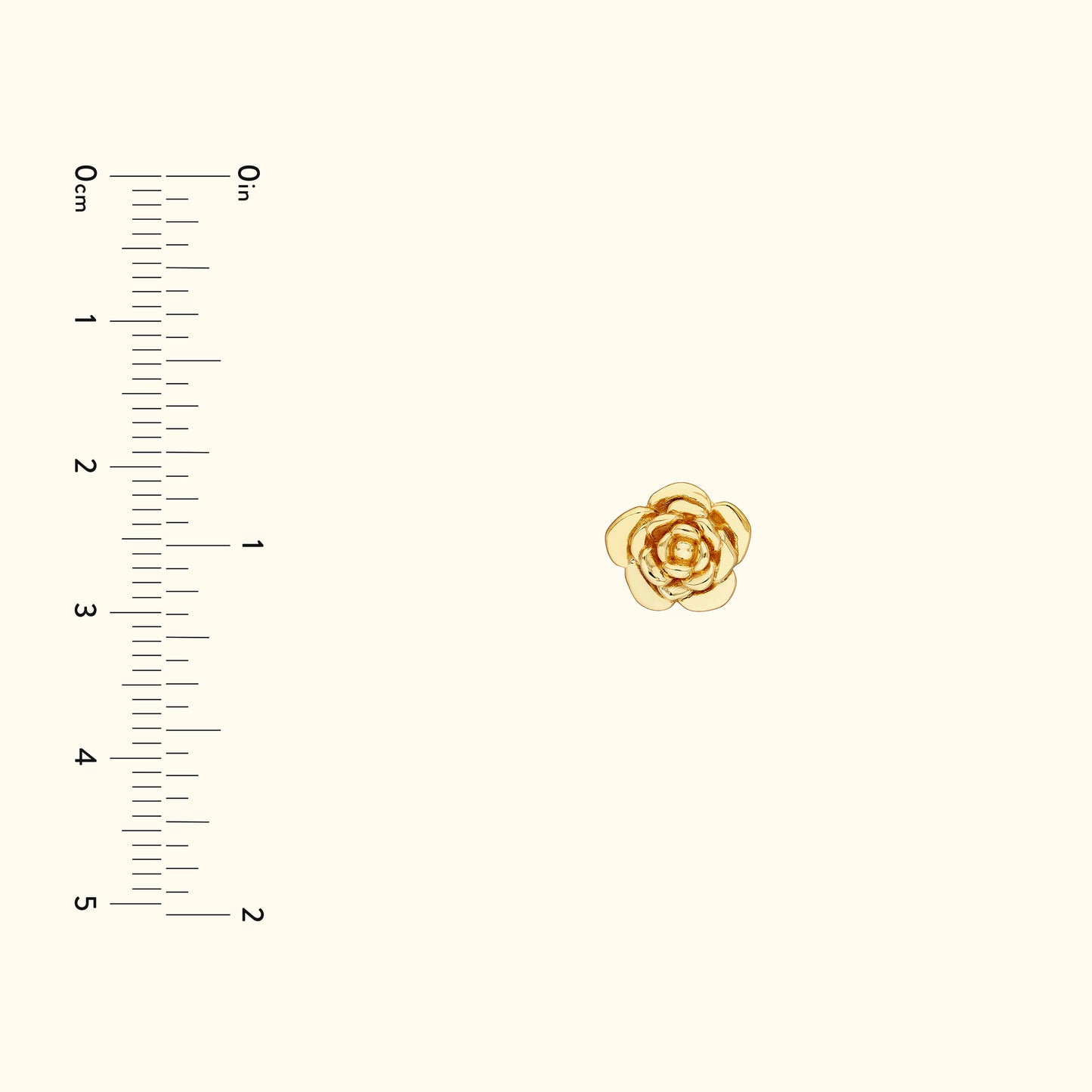 Delicate gold rose pin with layered petals on a light background, with a ruler for scale.