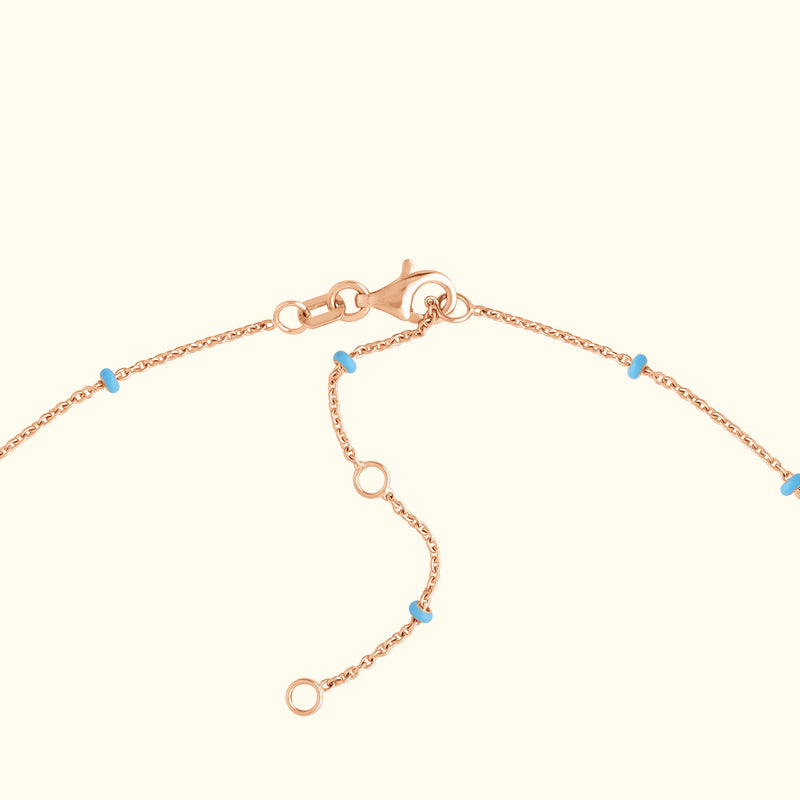 Rose gold bracelet chain with small turquoise beads and a lobster clasp.