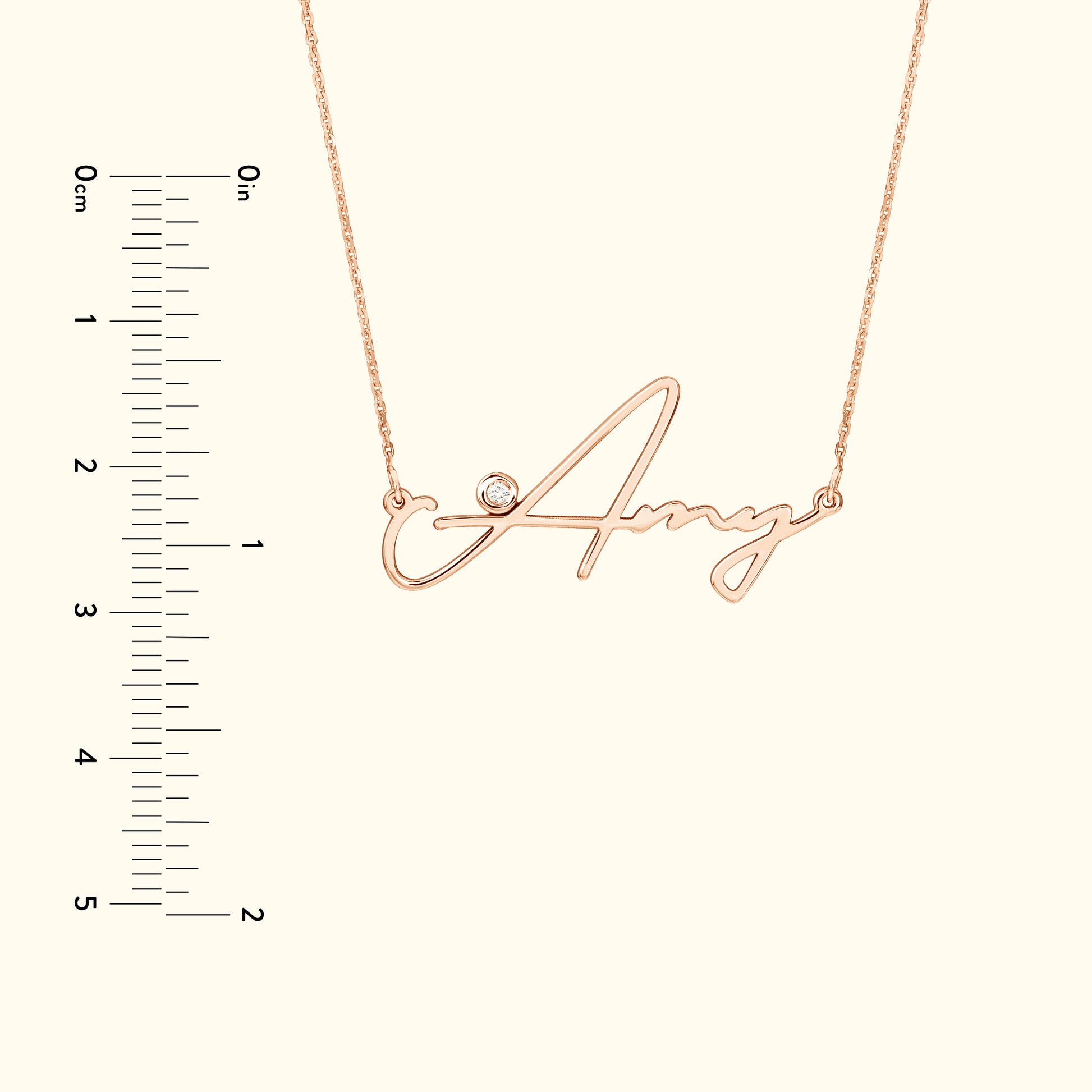 Rose gold name necklace featuring the name "Amy" with a small diamond accent.