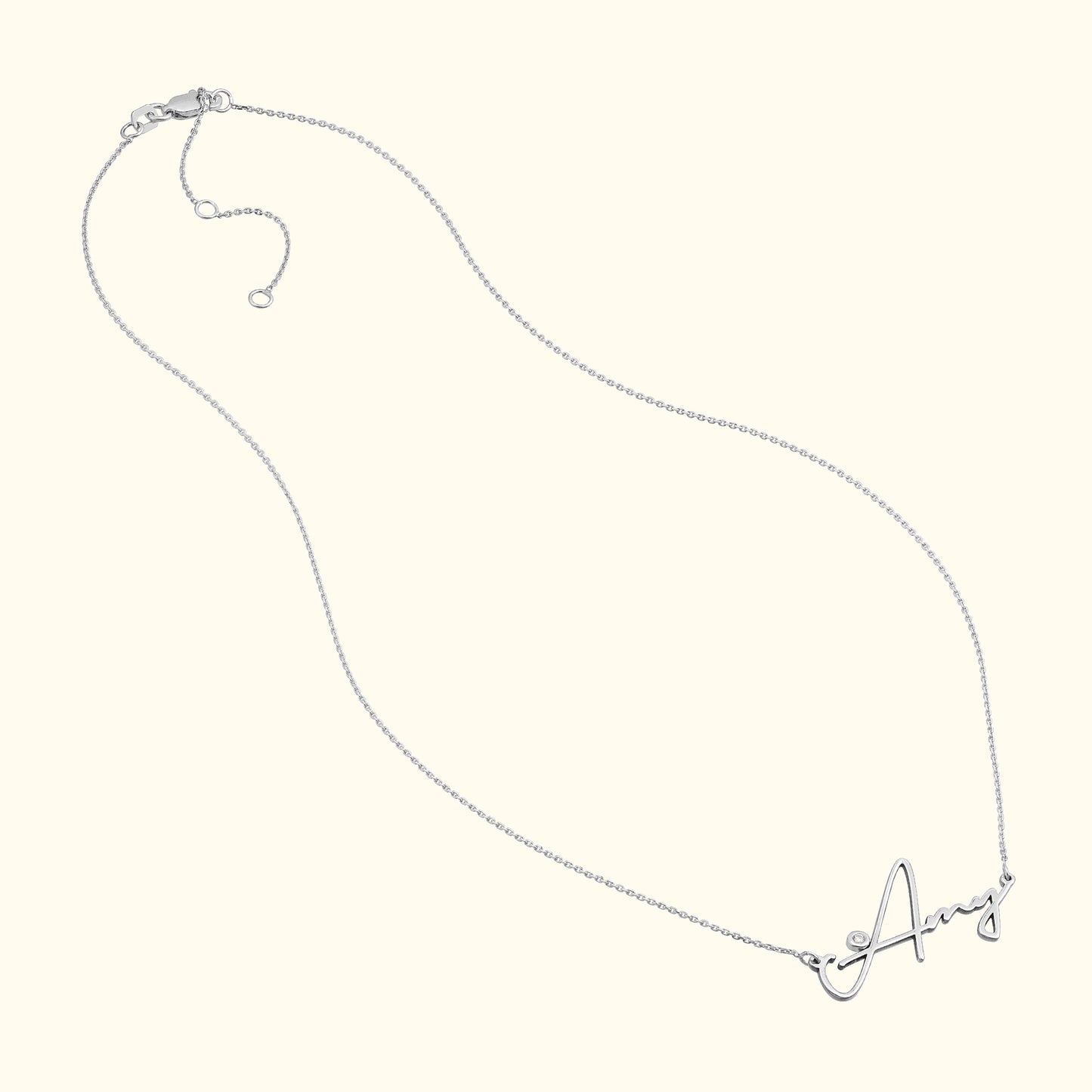 Silver necklace with a cursive letter "A" pendant.