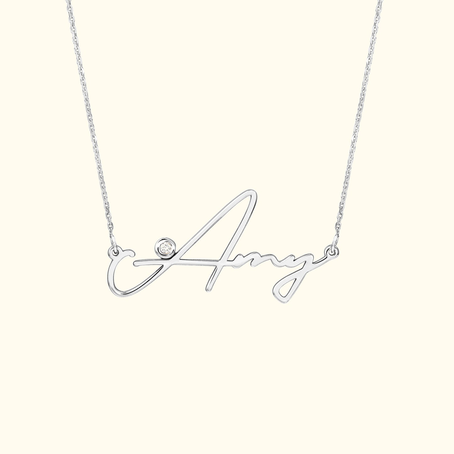 Silver necklace with a cursive name "Amy" and a small diamond accent.
