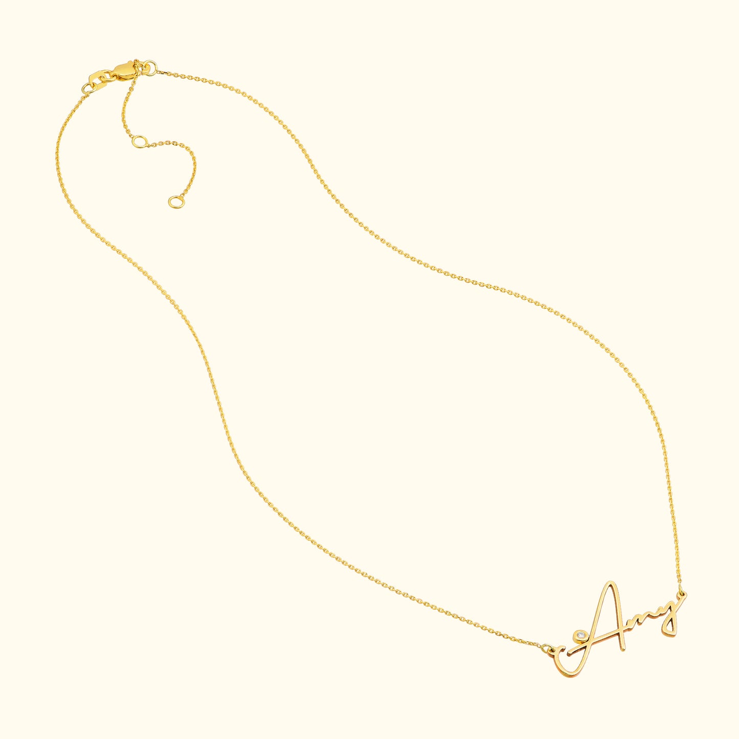 Gold necklace with a cursive letter "A" pendant.