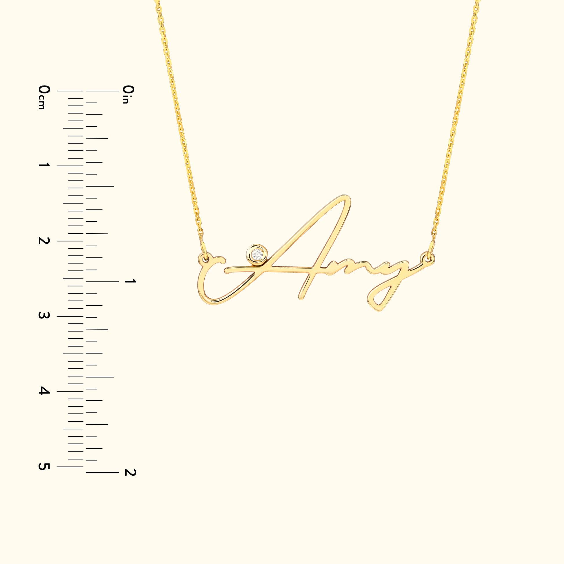 Gold necklace with the name "Amy" in cursive, featuring a small diamond accent.