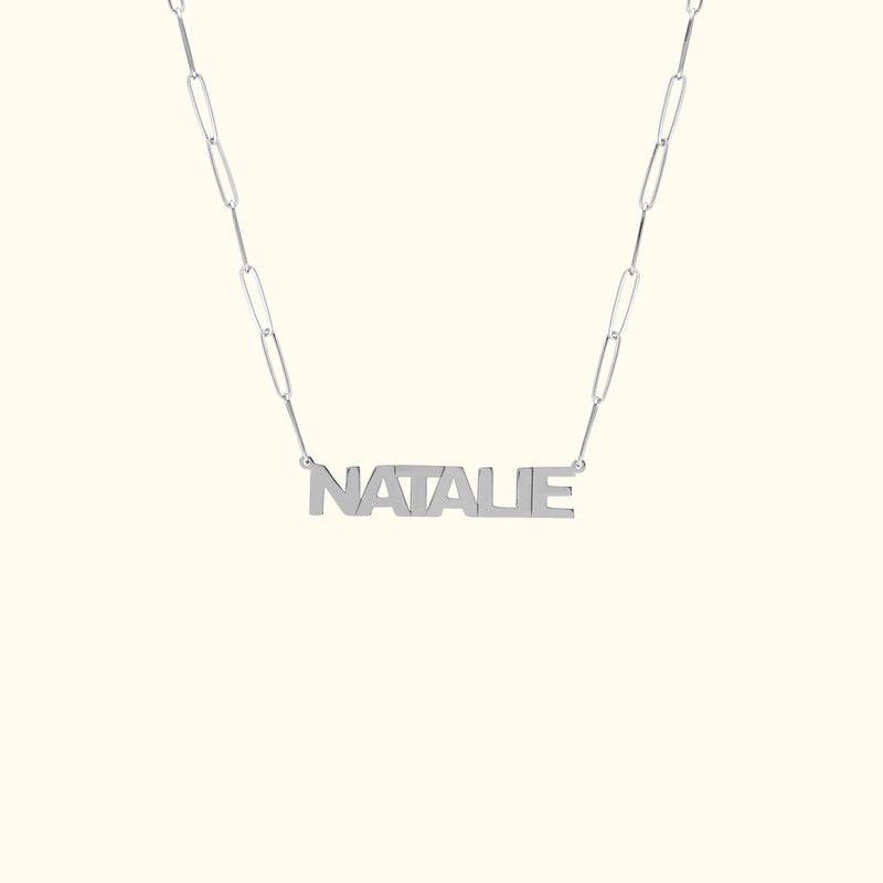 Personalized silver necklace with the name "NATALIE" on a linked chain.