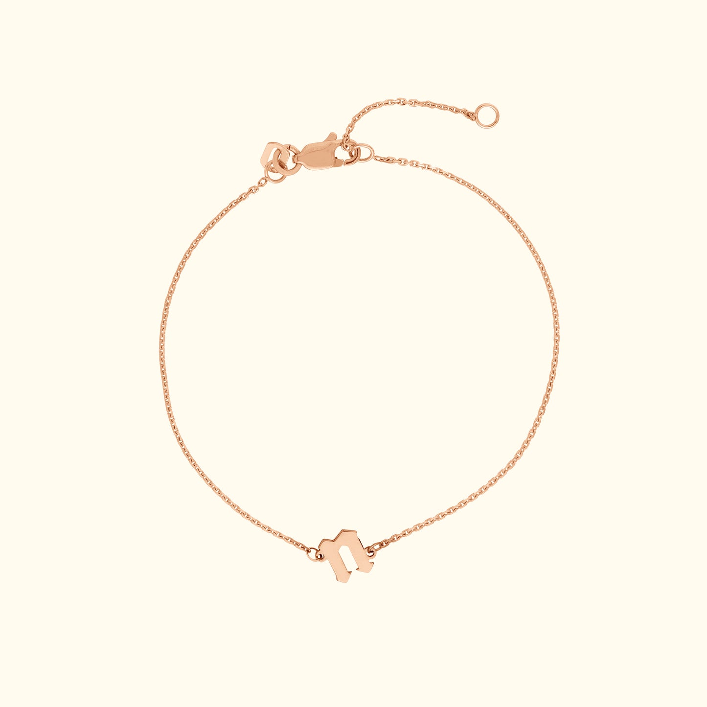 Delicate rose gold bracelet with a simple charm and adjustable clasp.
