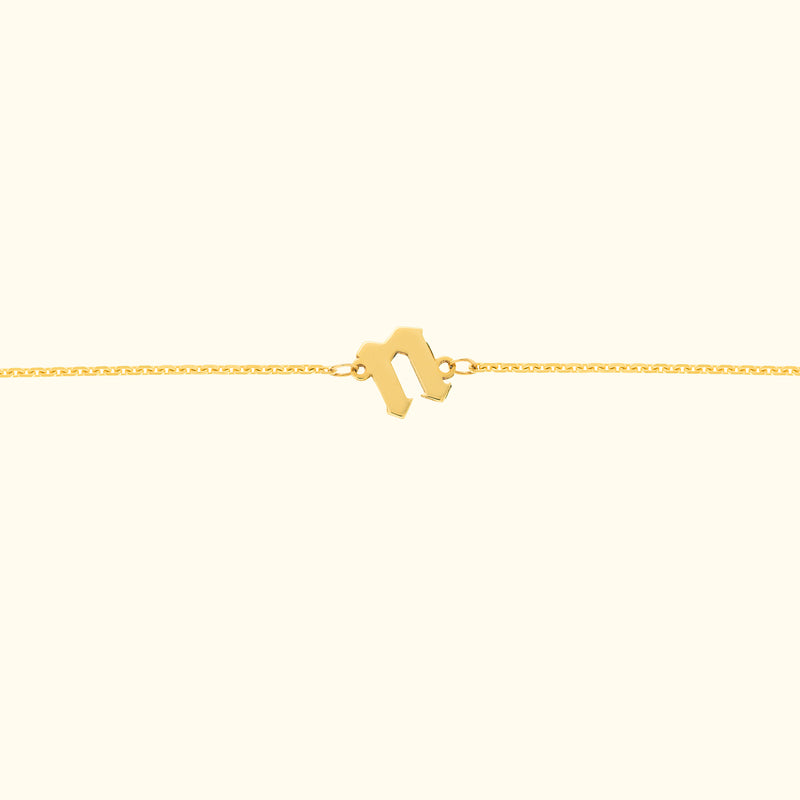 Delicate gold bracelet with a unique clasp design.