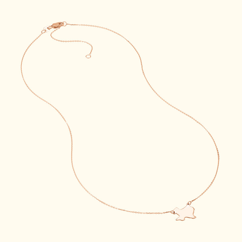 Delicate rose gold necklace featuring a playful outline charm.