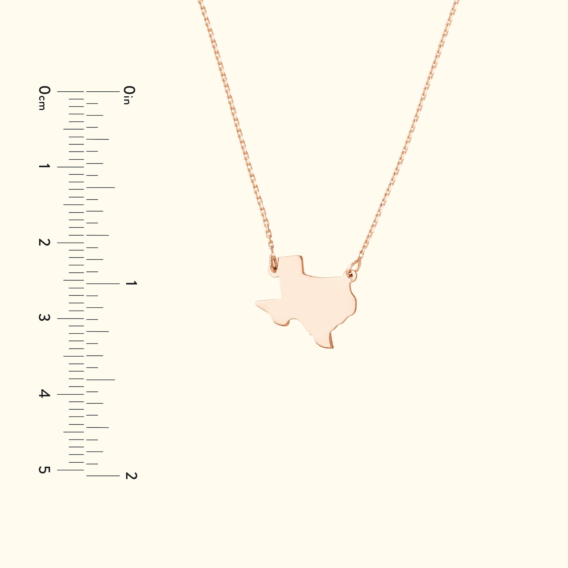 Rose gold necklace featuring a Texas state outline pendant.