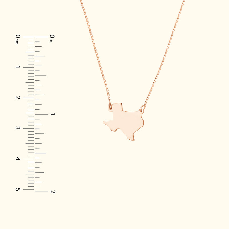 Rose gold necklace featuring a Texas state outline pendant.