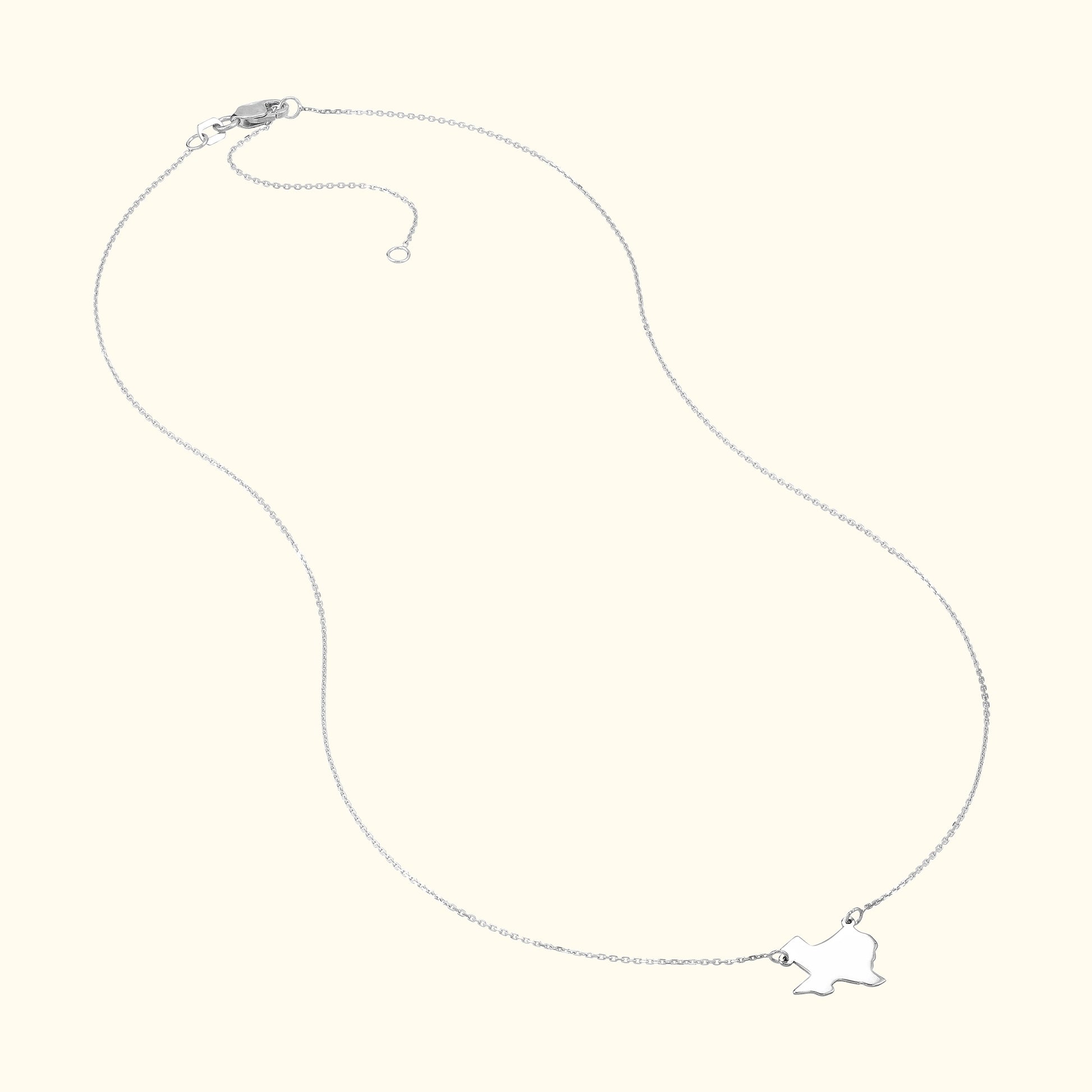 Delicate silver necklace with a small bird pendant.