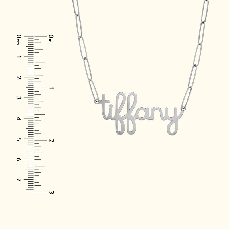 Silver necklace with a cursive "tiffany" pendant and linked chain.