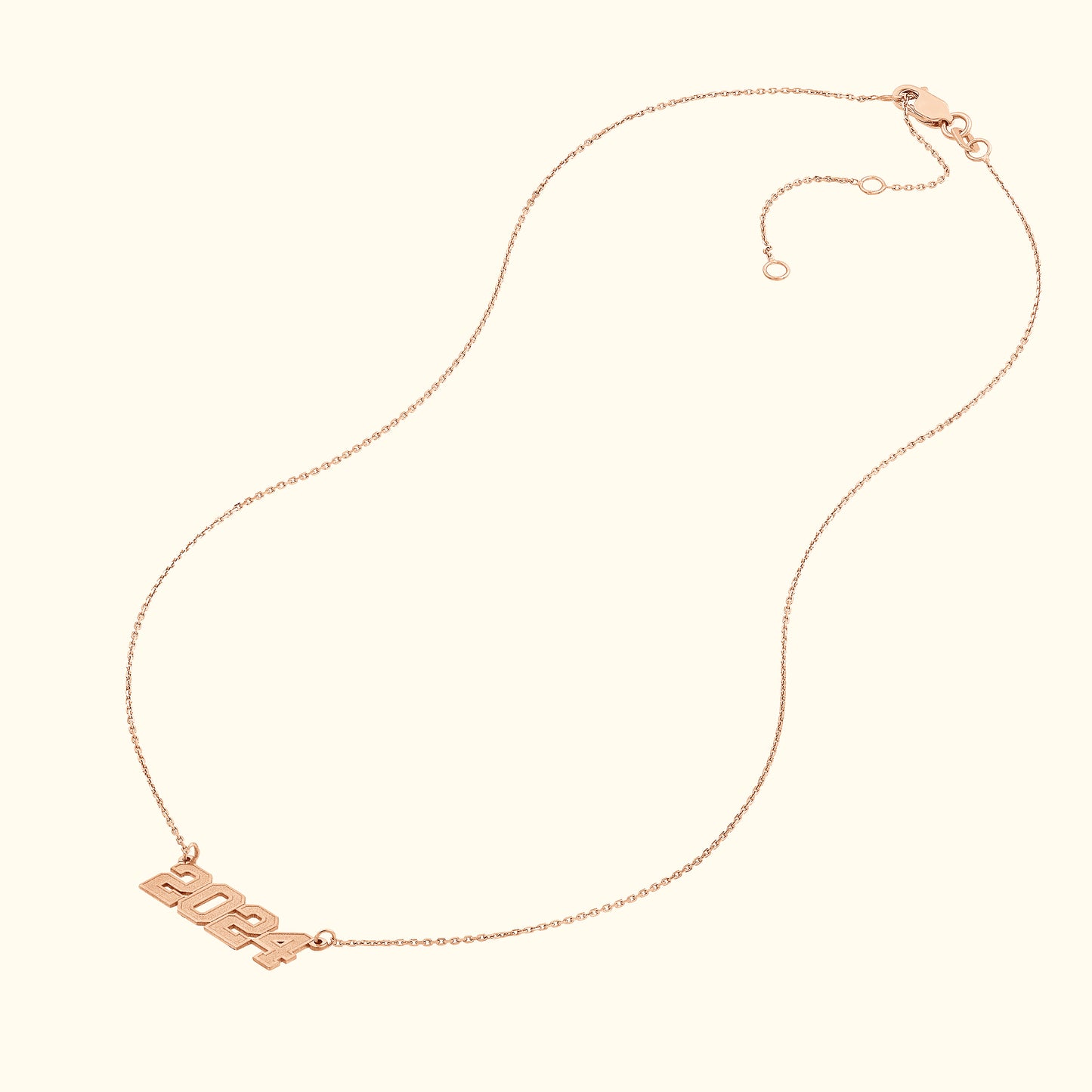 Rose gold necklace featuring a pendant with the year "2024".