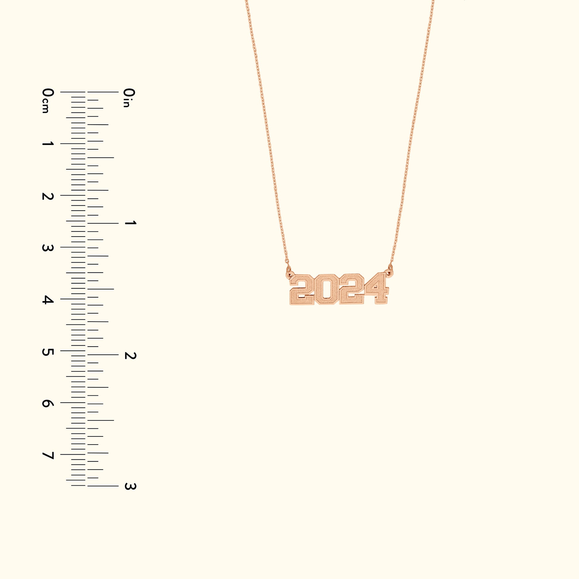 Rose gold necklace featuring the year "2024" as a pendant.