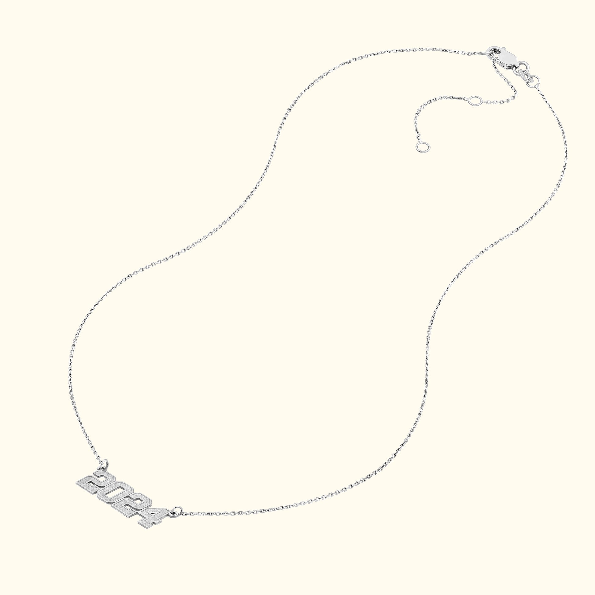 Silver necklace featuring a "2024" pendant on a delicate chain.