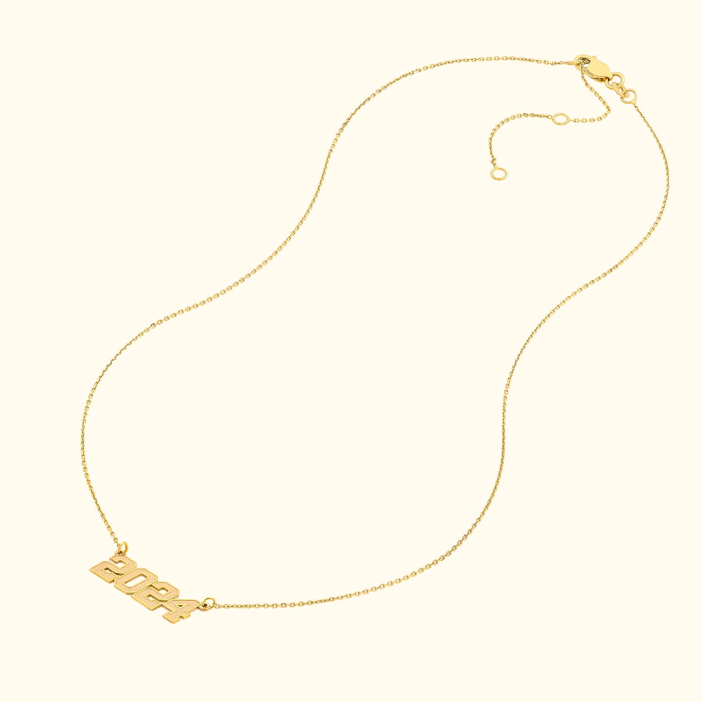 Gold necklace featuring the year "2024" as the central pendant.