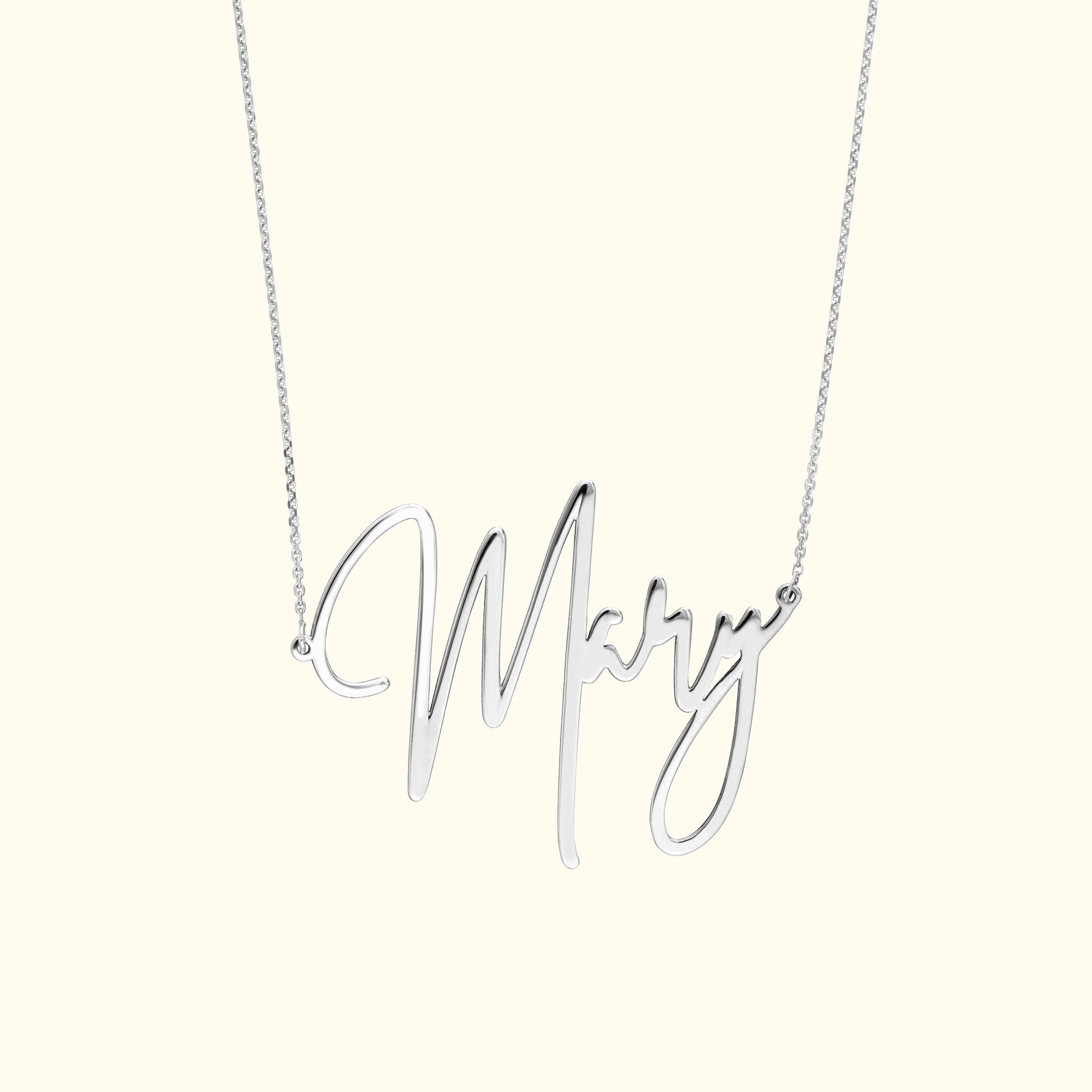 Silver necklace featuring a cursive 'Mary' pendant.