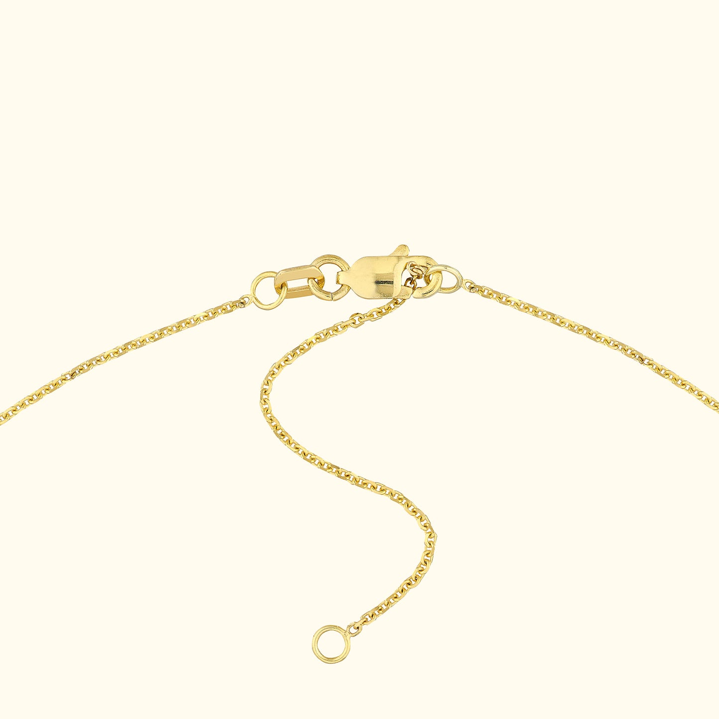 Close-up of a gold necklace clasp and chain links.